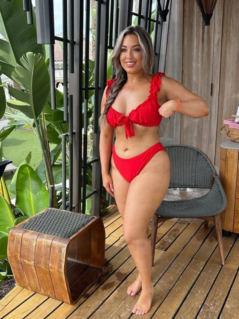 Nicole in a red bikini smiling at the Oasis Cabana at JW Marriott Orlando Grande Lakes.