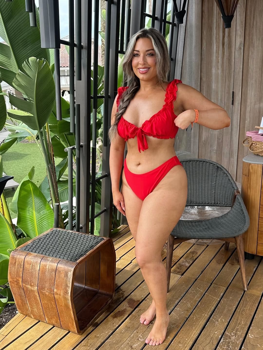 Nicole in a red bikini smiling at the Oasis Cabana at JW Marriott Orlando Grande Lakes.
